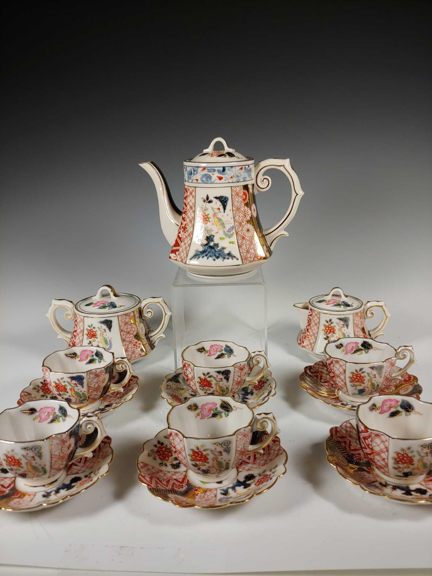Kosen Kutani China 15 Piece Tea Set: Complete 15 piece Kosen Kutani China tea set in gold, blue and orange with peacocks and floral decor. Teapot 5 1/2", cream and sugar 3 1/2", cups 1 3/4" and saucers 4 1/2". all in good age appropriate