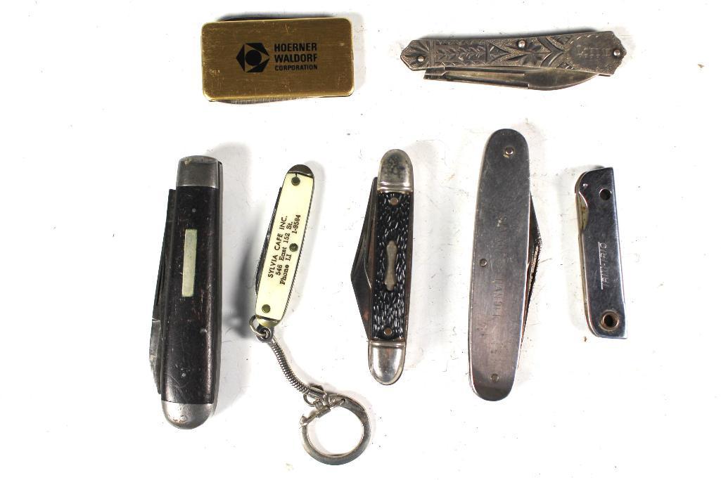7 Vintage Pocket Knives: Including; antique Sterling silver Camillus Cutlery, Ideal, Trim Pro, Imperial and advertising. All in age appropriate condition with signs of age and use, see photos.