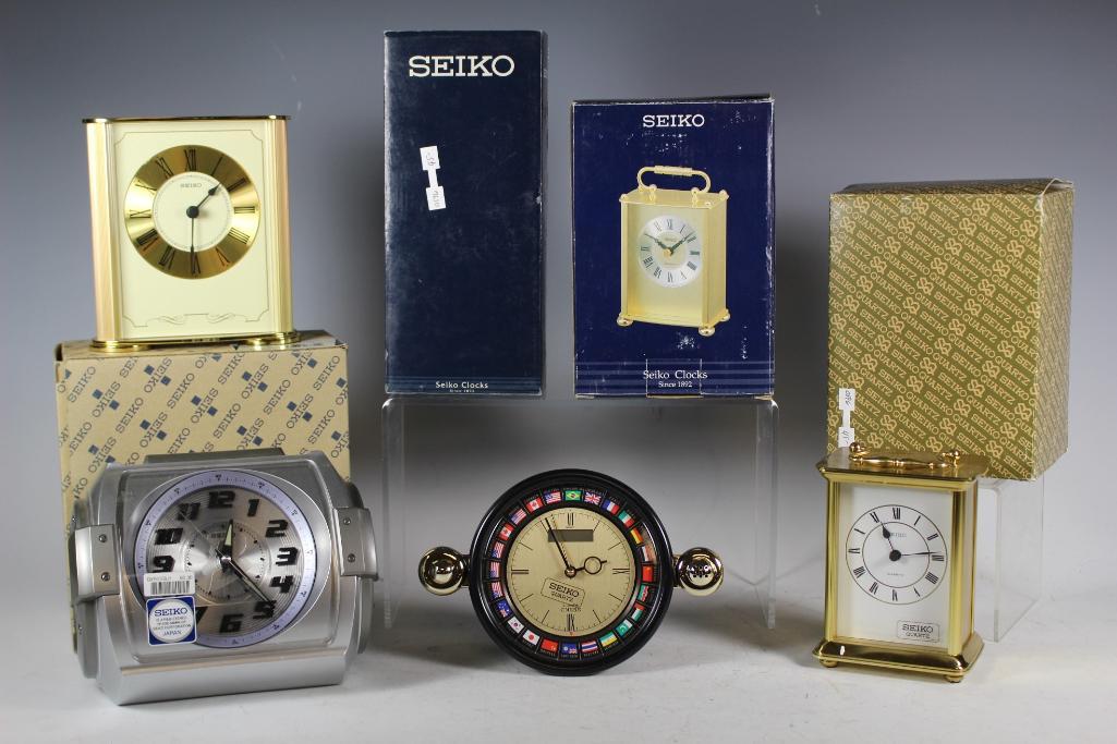 Collection of 6 Seiko Desk Clocks: Collection includes 2 Seiko brass carriage clocks, small mantle clock, Beat Club radio clock other and desk clock. All in good and new in box condition, see photos.