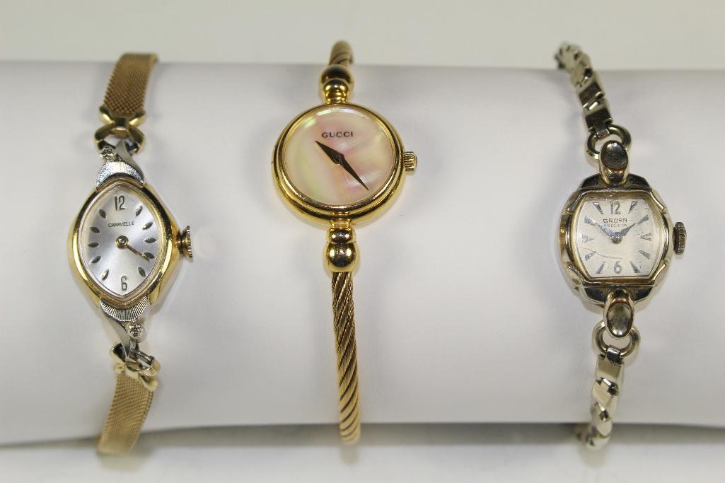 GUCCI CARAVELLE and GRUEN Ladies Watches: Three vintage ladies wrist watches to include: Early GRUEN with white 10k rolled gold and stainless, round face GUCCI and a gold toned CARAVELLE wind up in working condition. See photos