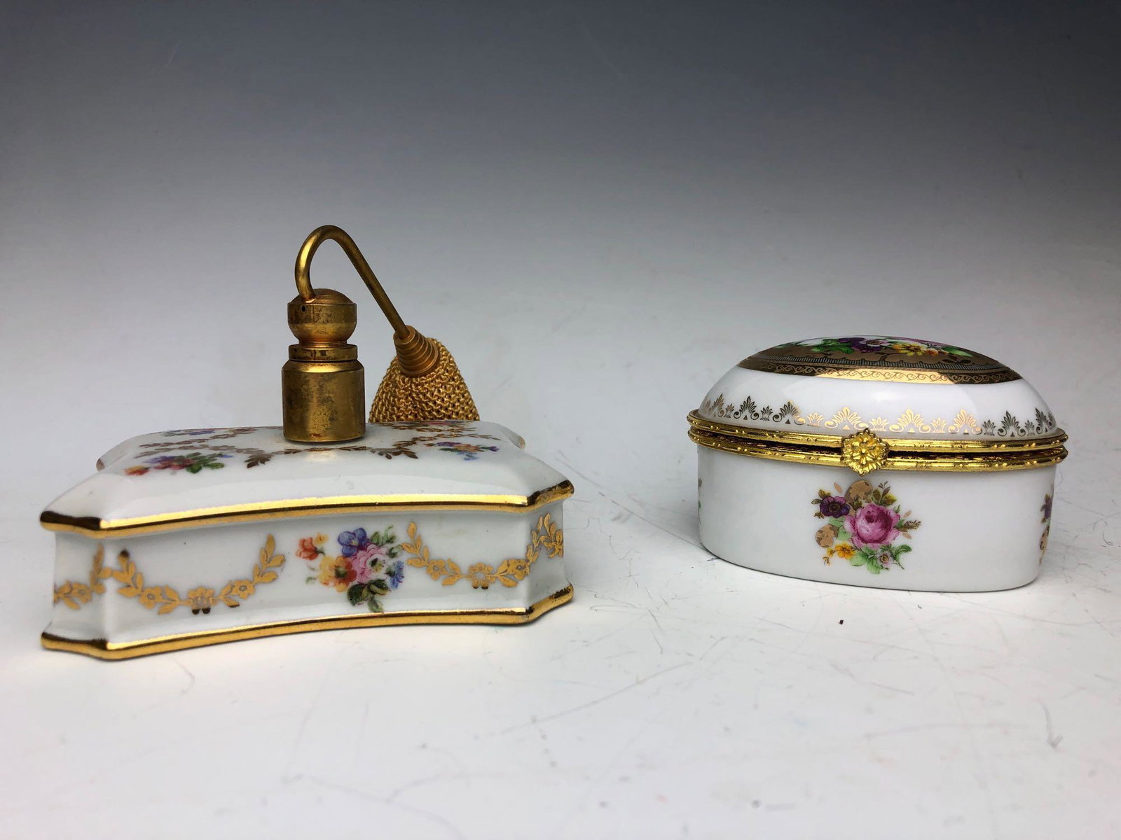 Vintage Limoges France Hand painted Floral Design: Vintage Limoges France Hand painted Floral Design Perfume Bottle and Hinged Trinket Box Lot. The perfume bottle dauber is missing and pump is hard -not in working condition. Measures approximately 2.5