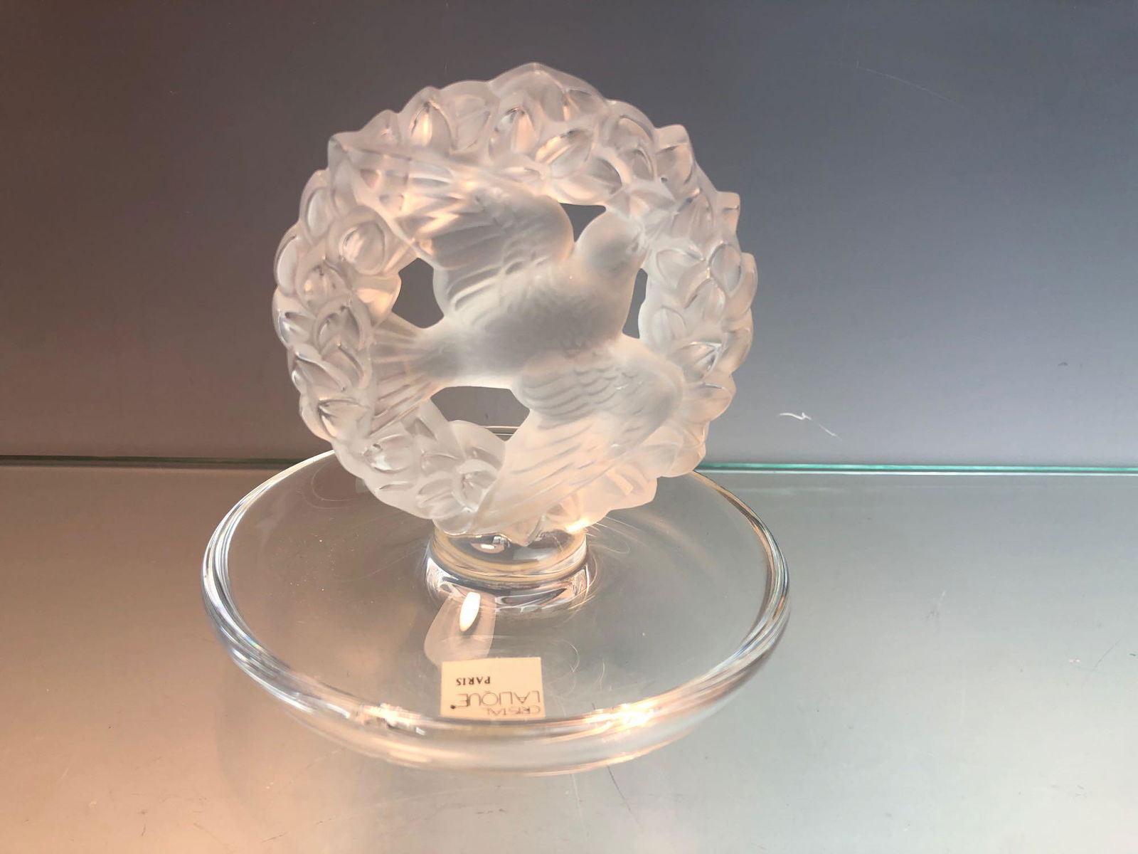 Lalique Frosted Crystal Bird / Dove in Wreath Ring: Lalique Frosted Crystal Bird / Dove in Wreath Ring Holder Signed w/ Original Box and paperwork France #10754. Good condition with no chips or cracks. Box has some shelf wear. Please see pictures. Meas
