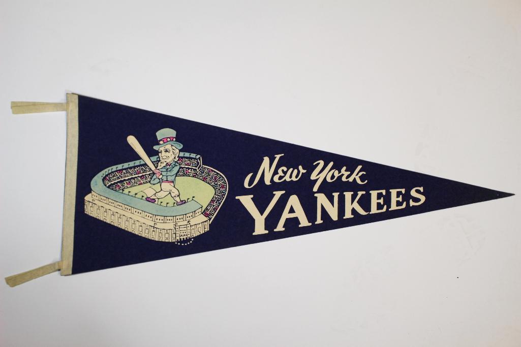 Blue 1950's New York Yankee Uncle Sam Pennant: Full sized pennant, blue felt, white tassels and design. Features Uncle Sam swinging in the stadium. This version has light blue colors on the top of the stadium and Uncle Sam. Pinhole towards the tip