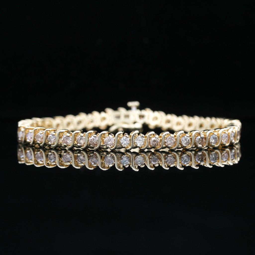 14k Yellow Gold "S" Link 3.00 CTW Diamond Tennis: 14k yellow gold "S" Link diamond bracelet.14K yellow gold10.4 dwt (inclusive of all materials) Bracelet length: 7"Stones: Diamonds(41) Round Cut Color: Top light brown Clarity: SI2 - I1 Stone Measurem