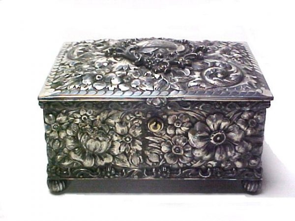Wonderful Repose Jewelry Box: silver plated case decorated high relief of flowers. Monogrammed Jesse. Condition no key, tarnishing and wear to finish. h.3'' d 4'' w.5''