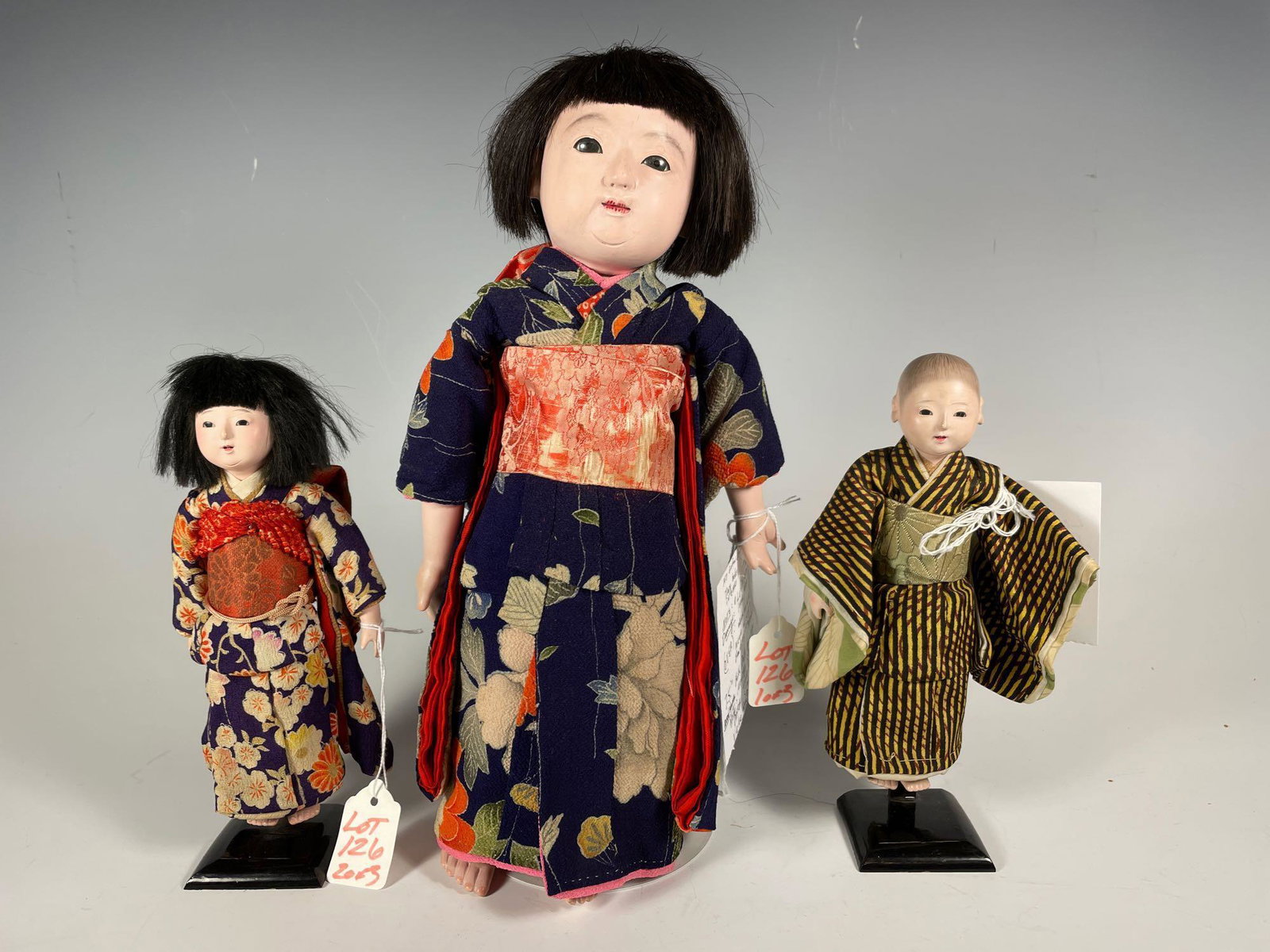 Three 14" Two 7.5" Signed Ichimatsu Gofun Japanese: Three 14" Two 7.5" Signed Ichimatsu Gofun Japanese Dolls Circa 1880's-1890's. Pair of boy and girl with all dolls wearing original Kimonos. 14" girl is signed on front of paper with painted nails on h