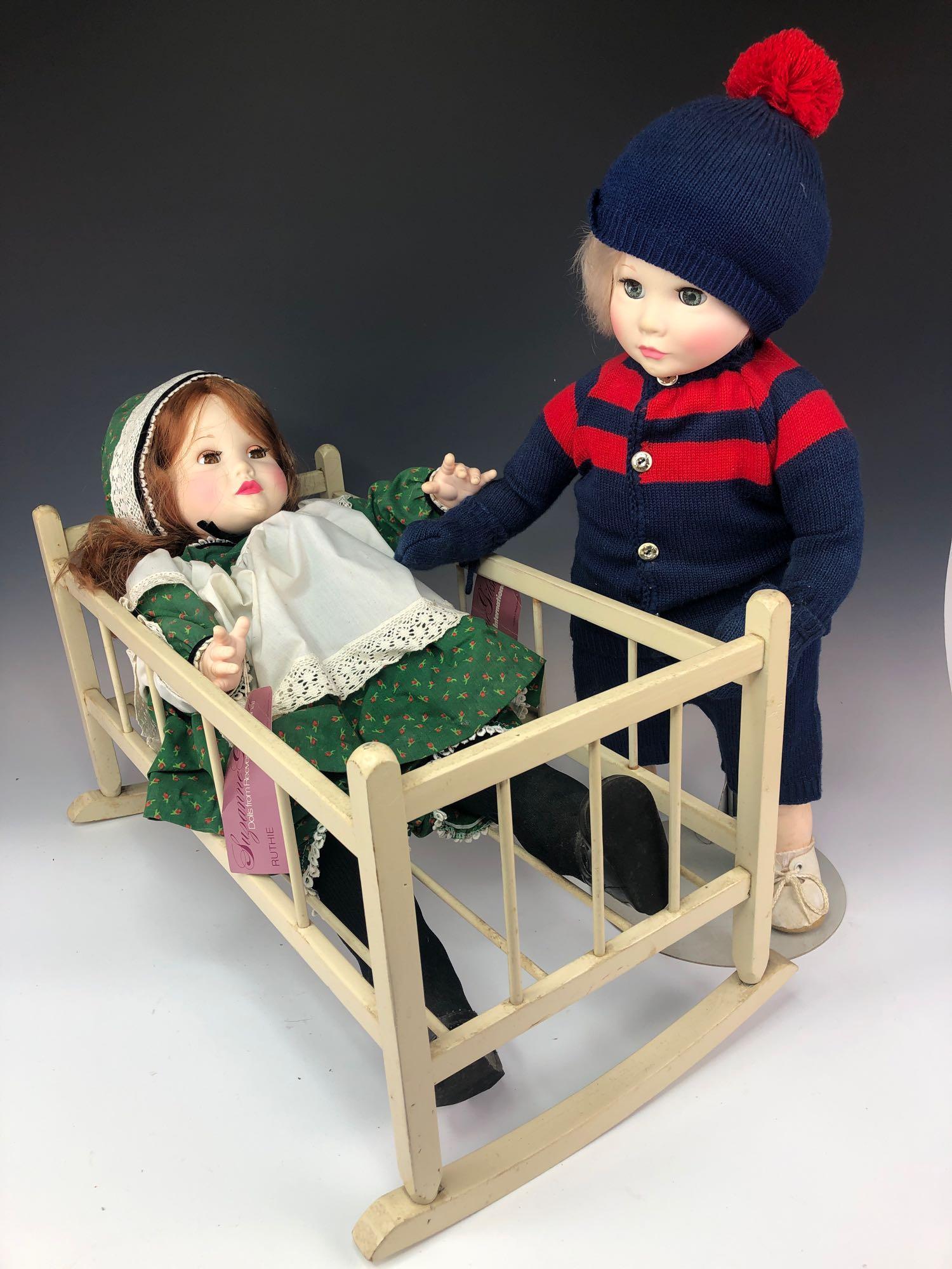 2 Vintage Suzanne Gibson Dolls with Wooden Crib: 2 Vintage Suzanne Gibson Dolls with Wooden Crib. Good overall condition- please see the pictures. Crib measures 12" x 20.25" x 10.5" Dolls are approximately 22" tall with orig tags