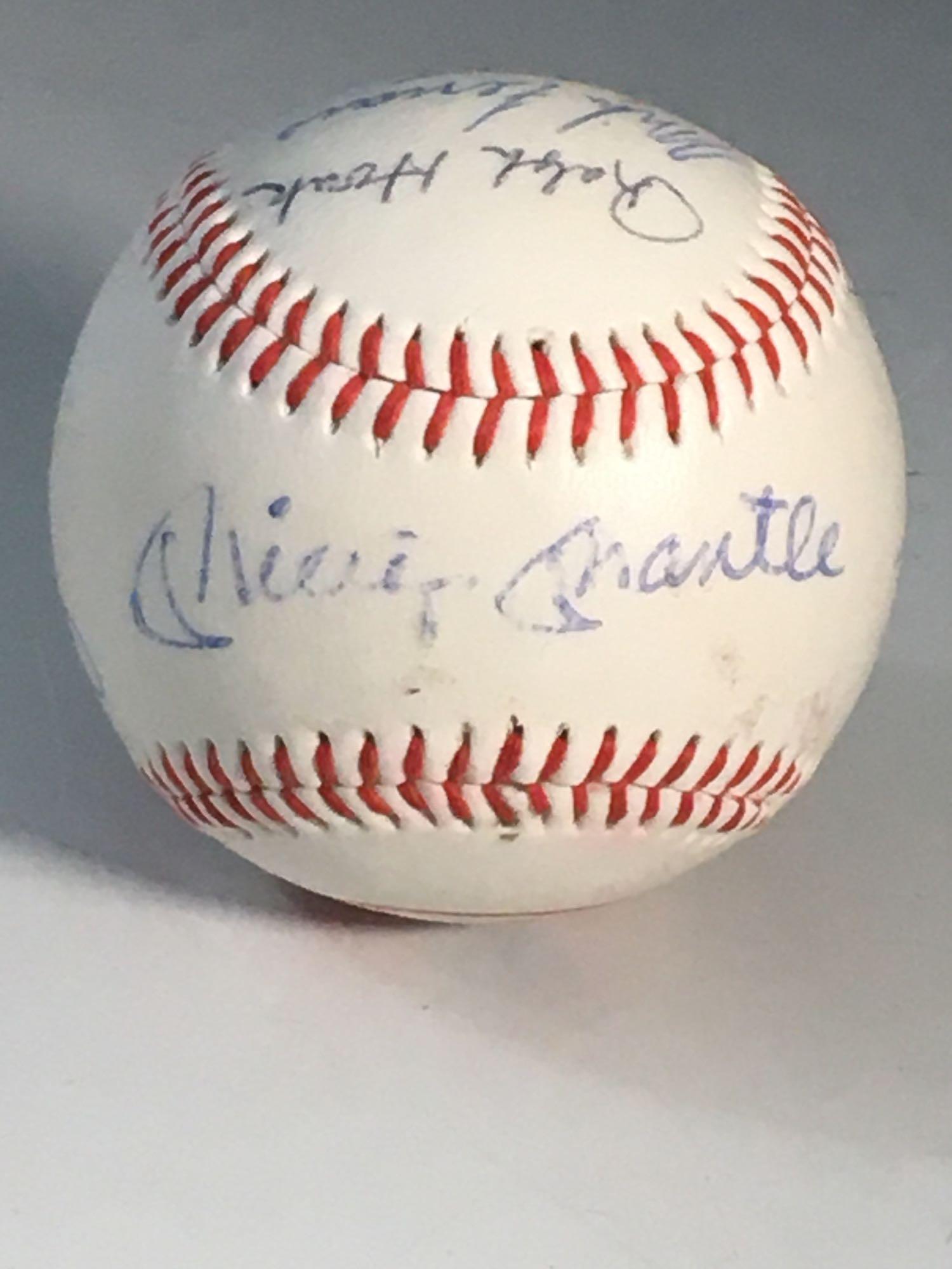 New York Yankees Autographed Baseball w/ Mickey Mantle: New York Yankees logo baseball with (9) signatures including Mickey Mantle on the sweet spot, Whitey Ford, Enos Slaughter, Bucky Dent, Ralph Houk, Ramos, Ferraro(coach) and Bahnsen(1968 ROY). Some sig