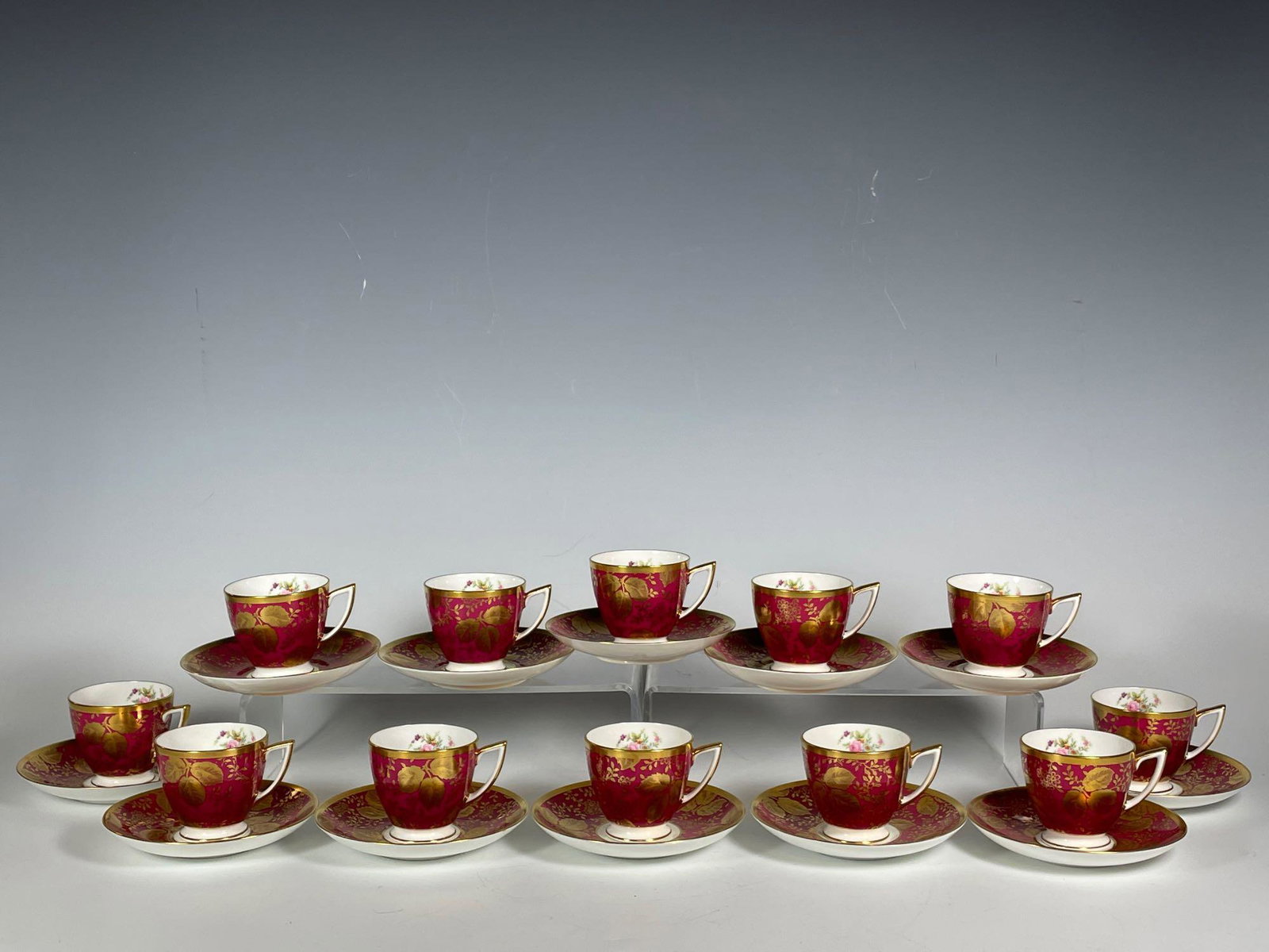 Set of Twelve MINTON Demitasse Cups and Saucers: Burgundy, gold overlay and floral decor. Stamped Minton as shown. Saucer approx 5" dia and cups 2.5" tall. Note one cup with interior hairline otherwise good.