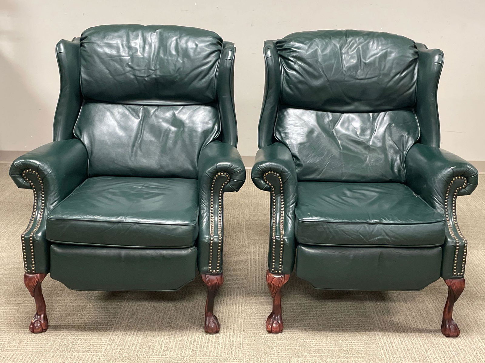 Pair of Dark Green Leather Barcalounger Recliners: Matching pair of dark green leather recliners by The Barcalounger Company. In good condition with light signs of wear consistent with use, see photos.