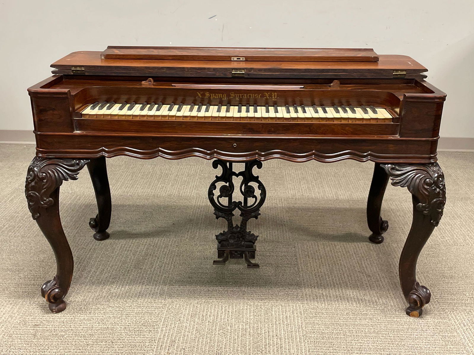 Mid 19th Century Carved Rosewood Melodeon: Measuring approx. 32" tall by 54" wide and 25" deep. Rosewood case in very good to excellent condition although bellow has lost compression.