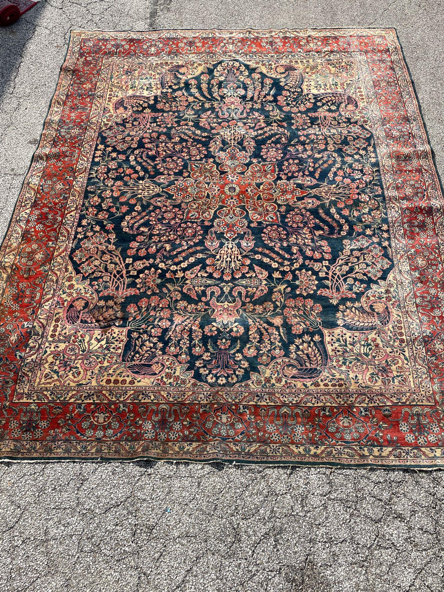 Antique Room Size Persian Sarouk Carpet: Early Persian antique room sized Sarouk carpet measuring approx 13ft x 10ft. Age appropriate condition as shown, see photos. Was cleaned prior to delivery to Premier Auction Galleries.