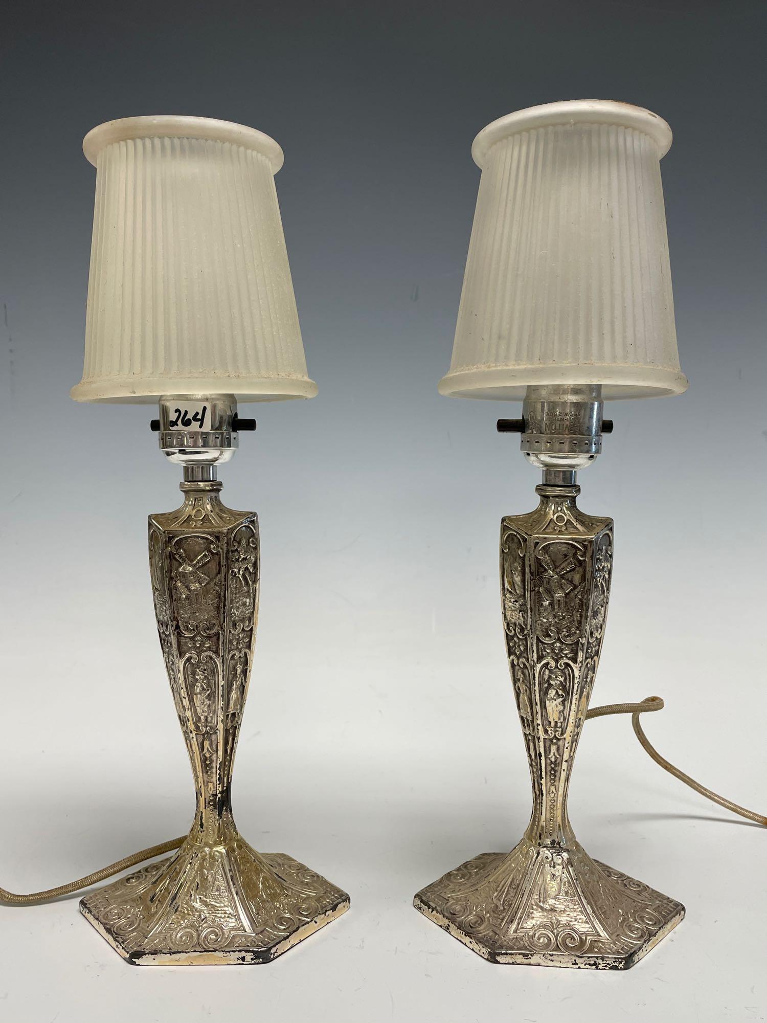 Pair of Antique E & J B New York Boudoir or Mantle: Fine pair of silver plates mantle lamps with frosted pleaded art glass shades. Silver plated body by E and J.B of New York as stamped on bottom features raised relief decorated panel body with windmil