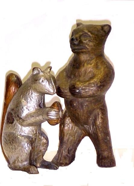 Cast Iron Still Banks Squirrel, Standing Bear, : both having normal paint loss otherwise good. Large Mean Standing Bear made by Arcade and appears foot has crack or repaired. Bear 5 1/2'' h. Squirrel 4'' h.