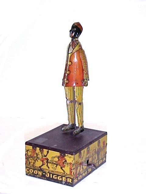 Marx Somstepa Coon Jigger Wind-up Toy: Tin litho, 8" tall, Marx maker marks in several locations, still works good. Lithographic's have light crazing and paint wear.