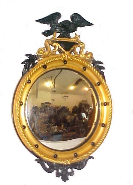Federal Style Eagle / Dolphin Bullseye Mirror,: In gilt wood and gesso frame. Having painted black Eagle and gilt Dolphin crest, convex mirror gadroon molded edge and lower scrolled crest. Minor age cracking. H. 36'' dia. 23''. Companion to lot 365