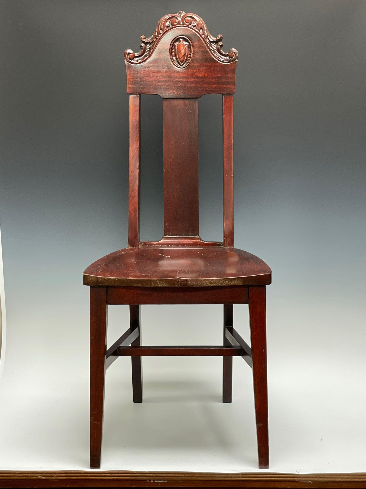 Carved 19th Century Mahogany Chair: Carved with shield family crest desk or piano chair. Standing approx 41" tall x 17" wide and 17.5" seat height. See photos