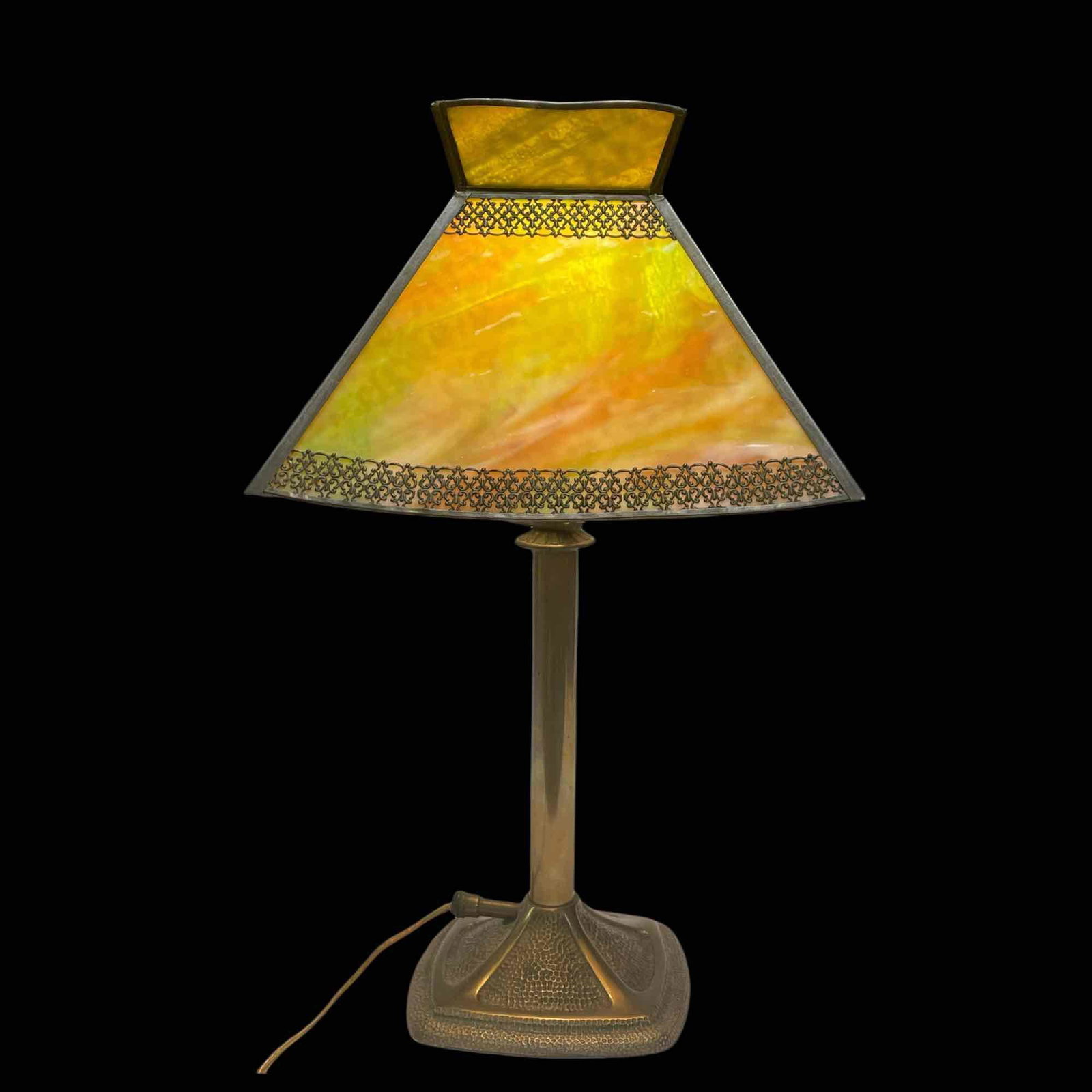 Arts and Crafts Slag Glass Lamp: American 1930's arts and crafts style green and carmel swirled slag glass seated on brass base. Working condition as shown. Missing on fret work border as shown, see photos for details.
