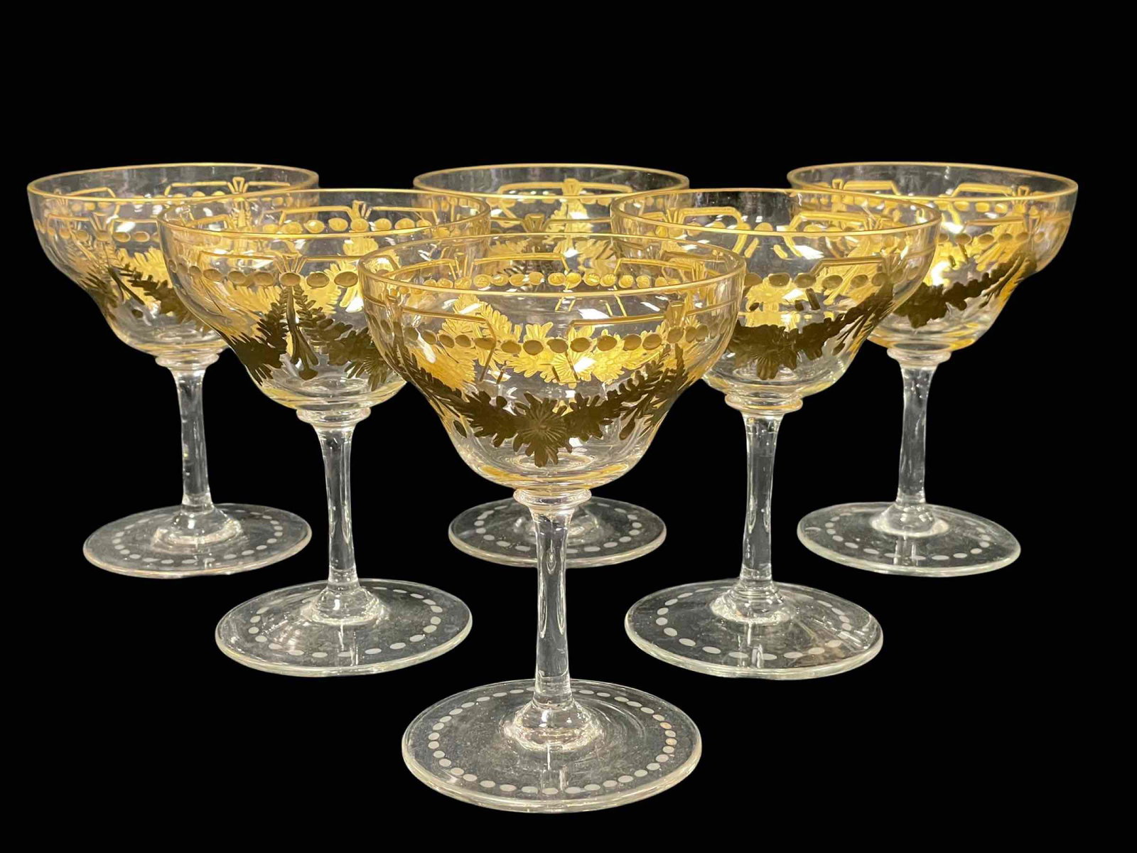 Six (6) Crystal Wine Stems w/ Gold Floral Drape Pattern: Six (6) crystal wine stemmed glasses with draped gold gilt floral pattern. Possibly Baccarat. Measuring approx 7" tall 5.25" diameter top. Normal use as shown, see photos.