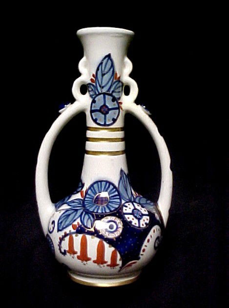 Amphora Austria Unusual Style Double Handle Vase,: in a very stylized pattern similar to Gaudy Welsh with gilt decoration. With all the right markings '' see photos'' Condition good h. 11''