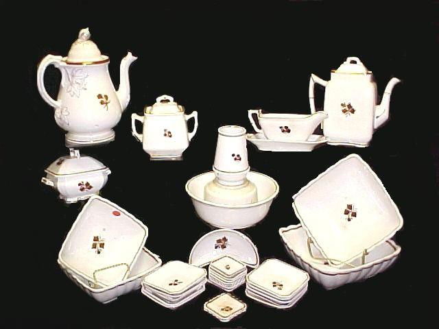 Collection Of Old Tea Leaf China Serving Dishes: to include 2 tea pots, 2 sugar bowls, 1 round bowl, 4 square bowls, spooner, waste bowl, gravy boat and under plate, 10 butter pads, 10 small square desert or sauce bowls, I large bone dish. Assemble