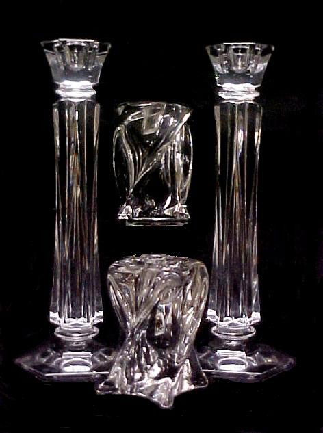 Two Pairs Of Signed Cut Crystal Candle Holders,: Tallest pair 12'' with slight twist formation, Ineligible signature '' initials T M in center, with wording above and below wreath. Second pair 4 1/2'' tall with stronger swirl design. Etched Signed i