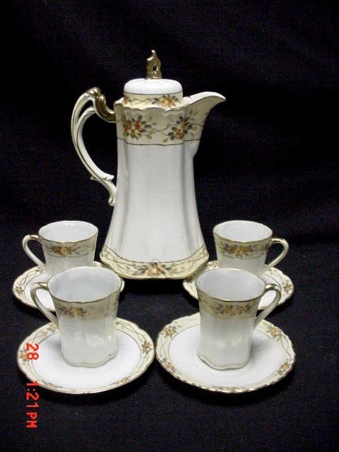 Nippon Five Hand Painted Piece Chocolate Set, : having borders of floral decoration and gold gilt trim. Coco pot 4 cups & saucers. Condition normal wear to gilted area's appropriate for age use, otherwise good. Coco pot 9 1/2'' cup 2 3/4''.