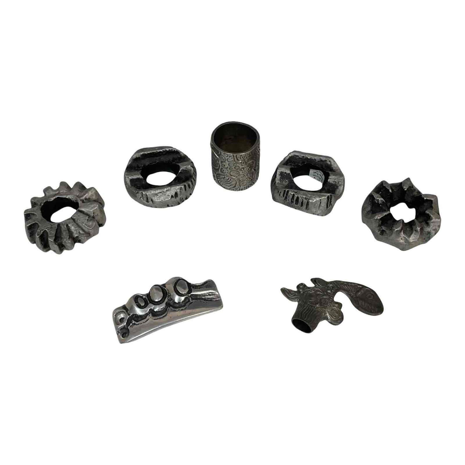 Group of Don Drumm Objects: A group of Don Drumm objects and fittings, including what appears to be a belt buckle, a napkin ring, wine cork topper (no cork), and other items which may be a set of 4 napkin rings. Not all pieces s