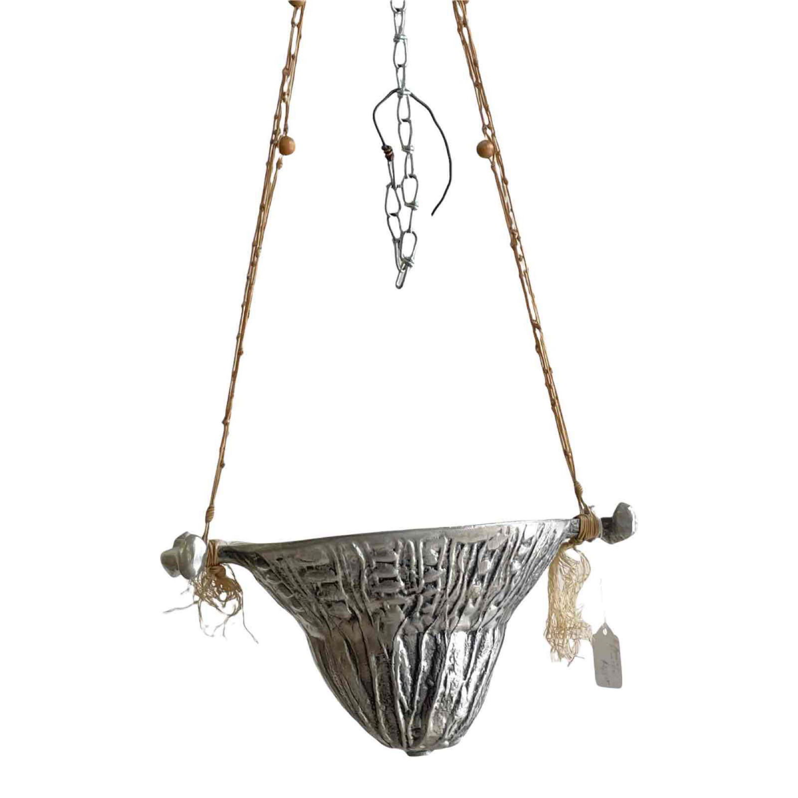 Don Drumm Hanging Planter: An unusual hanging planter from Don Drumm's early work, c. late 1960s or 70s in his characteristic alloy and Early Brutalist style. Signature very faint. Approximate dimensions: 6" h. x 12 1/2" w. (pl