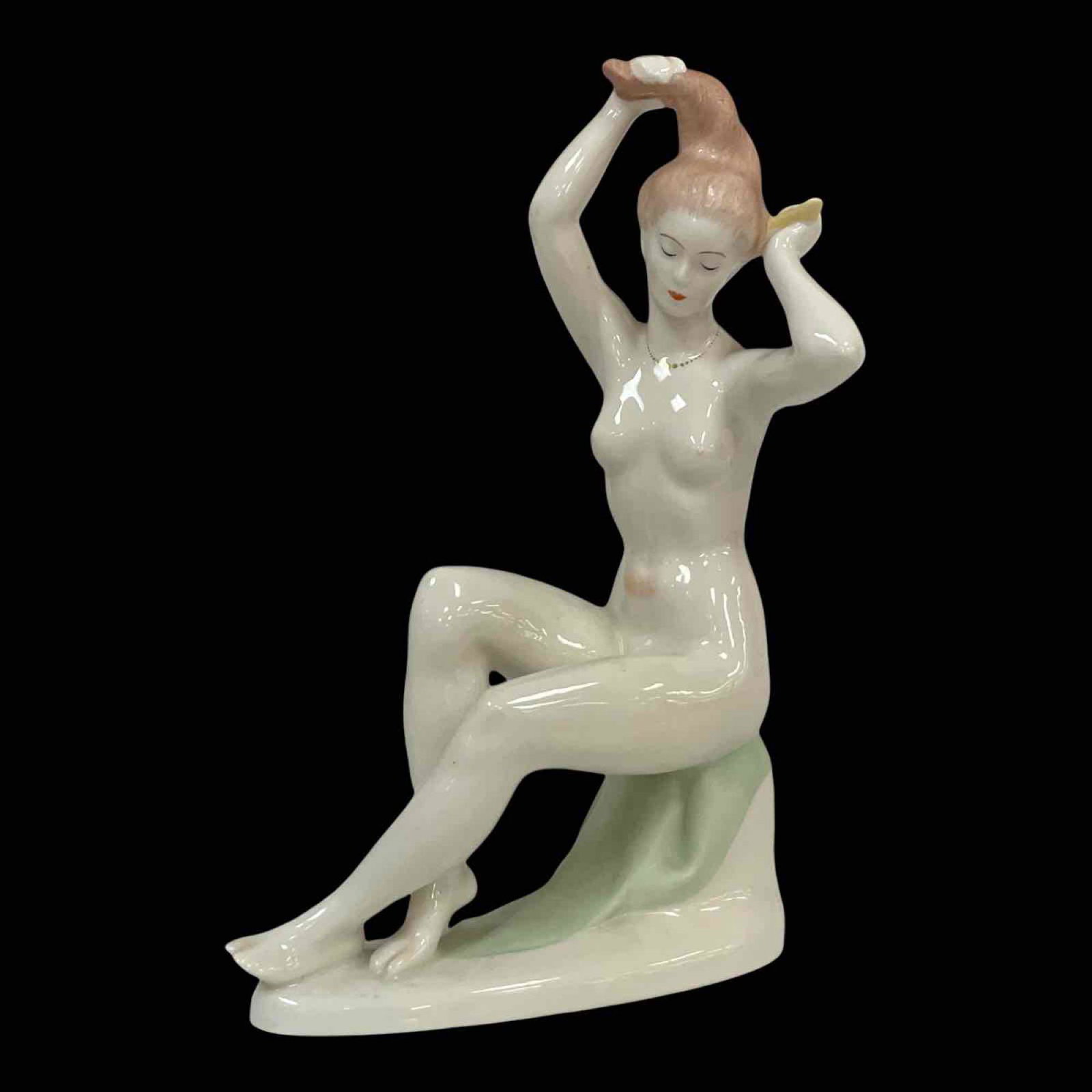 Hungarian Porcelain Bathing Nude Figurine: A risquÃ© porcelain figurine of a seated bathing nude female addressing her hair as shown. Aquincum Hungry, Art Deco. Standing approx 7" tall, good overall condition as shown, see photos.
