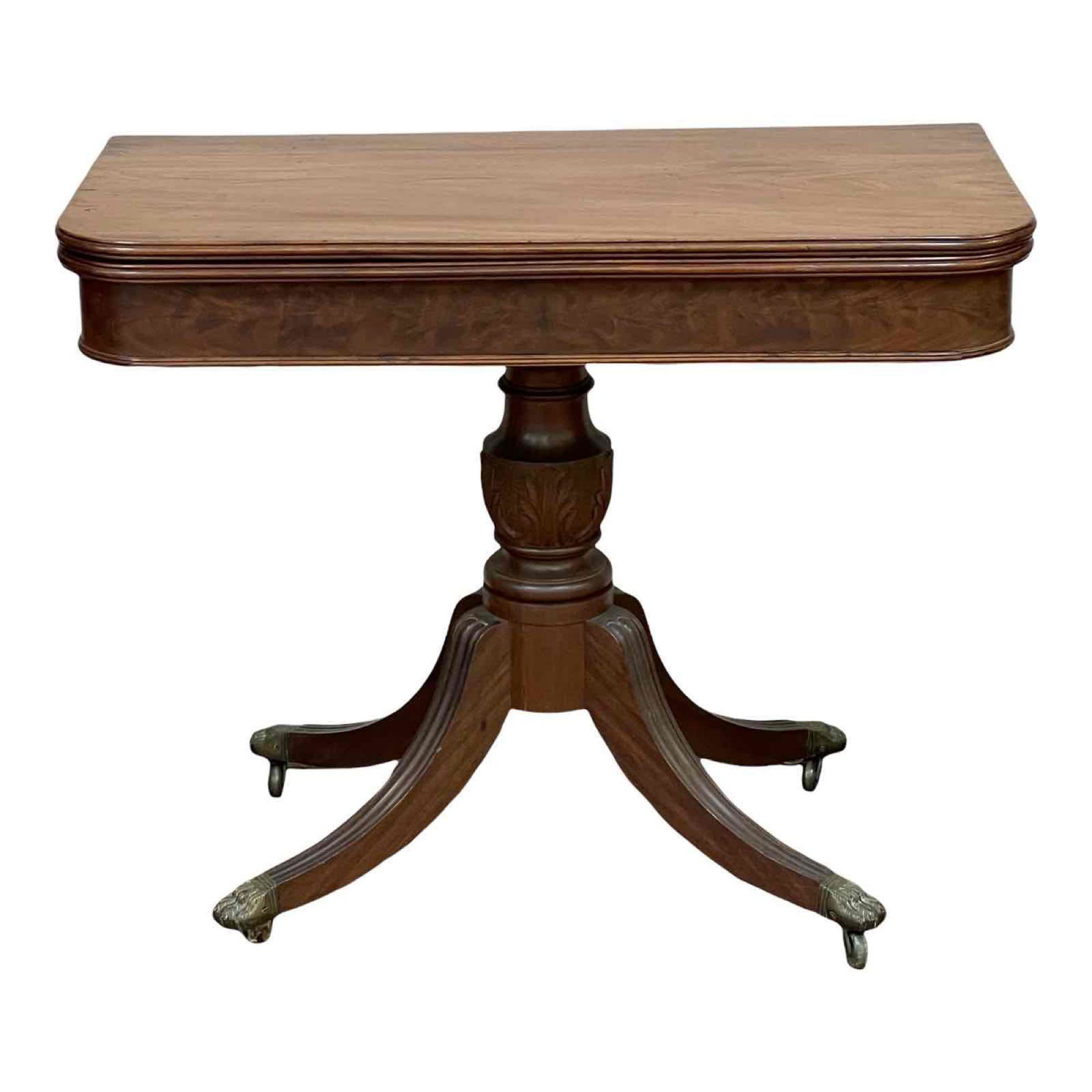 19th Century American Mahogany Pedestal Game Table: 19th Acanthus carved pedestal base with four legs brass capped with hairy paw feet seated on brass castors. Games table in manner of Duncan Phyfe. Some finish losses/fade and normal use and wear throu