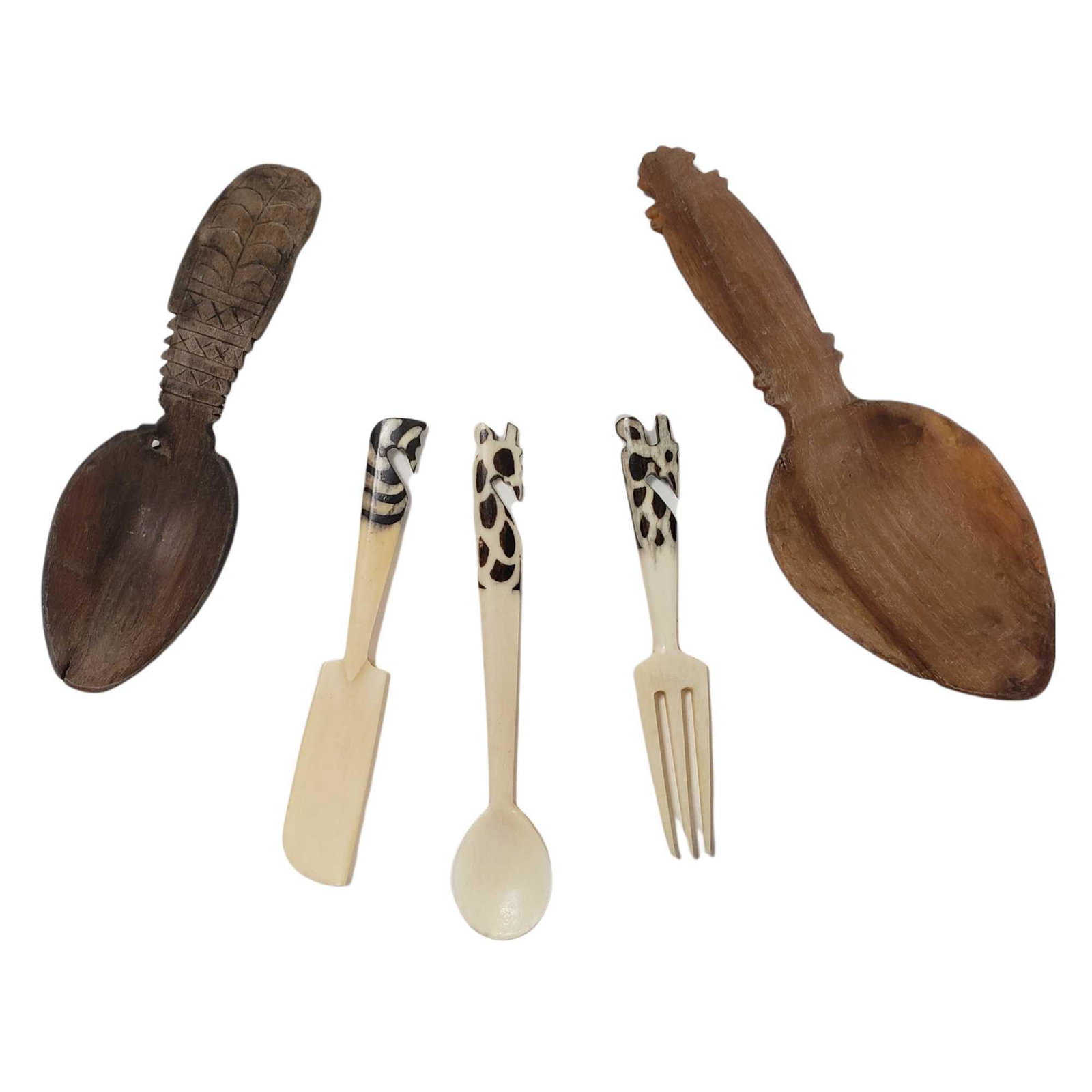 Bone and Horn Carved Utensils (5): Five piece carved bone and horn utensils including; two carved serving spoons and three carved bone setting of a fork, spoon and knife with carved zebra and giraffe tops. In good age appropriate condi