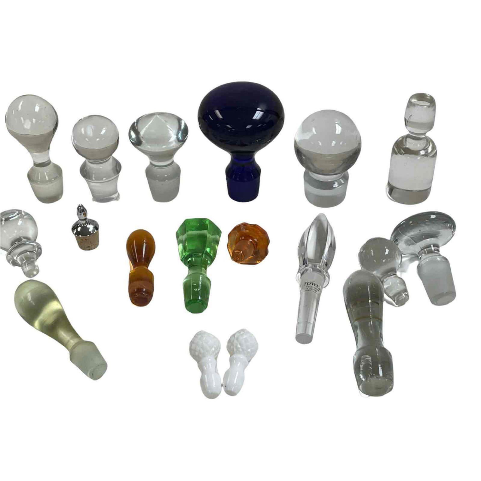Eighteen (18) Glass Bottle and Decanter Stoppers: 18 decanter and bottle stoppers largest measuring 4 1/2 inches down to 1.5 inches. Normally use and where some next to bottom sash I see photos.