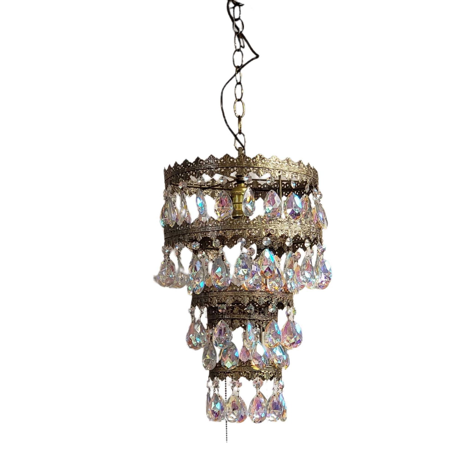 Four Tier Mid 20th Century Chandelier w Iridescent Prisms: Hanging chandelier with four level tiers with pendant iridescent crystal prisms. Overall measuring approx 18.5" tall to top ring x 11" at widest. Normal use and wear. 1960-70 era. See photos