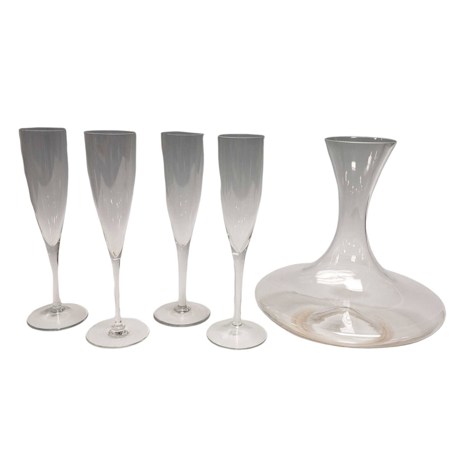 Baccarat Champagne Flute Riedel Ultra Wine Decanter and Three Other Flutes: Baccarat Champagne Flute Riedel Ultra Wine Decanter/ Carafe and Three Other Flutes. Measuring approx. 9" tall. Unable to find signature on decanter. One champagne flute does have chipped rim, see phot