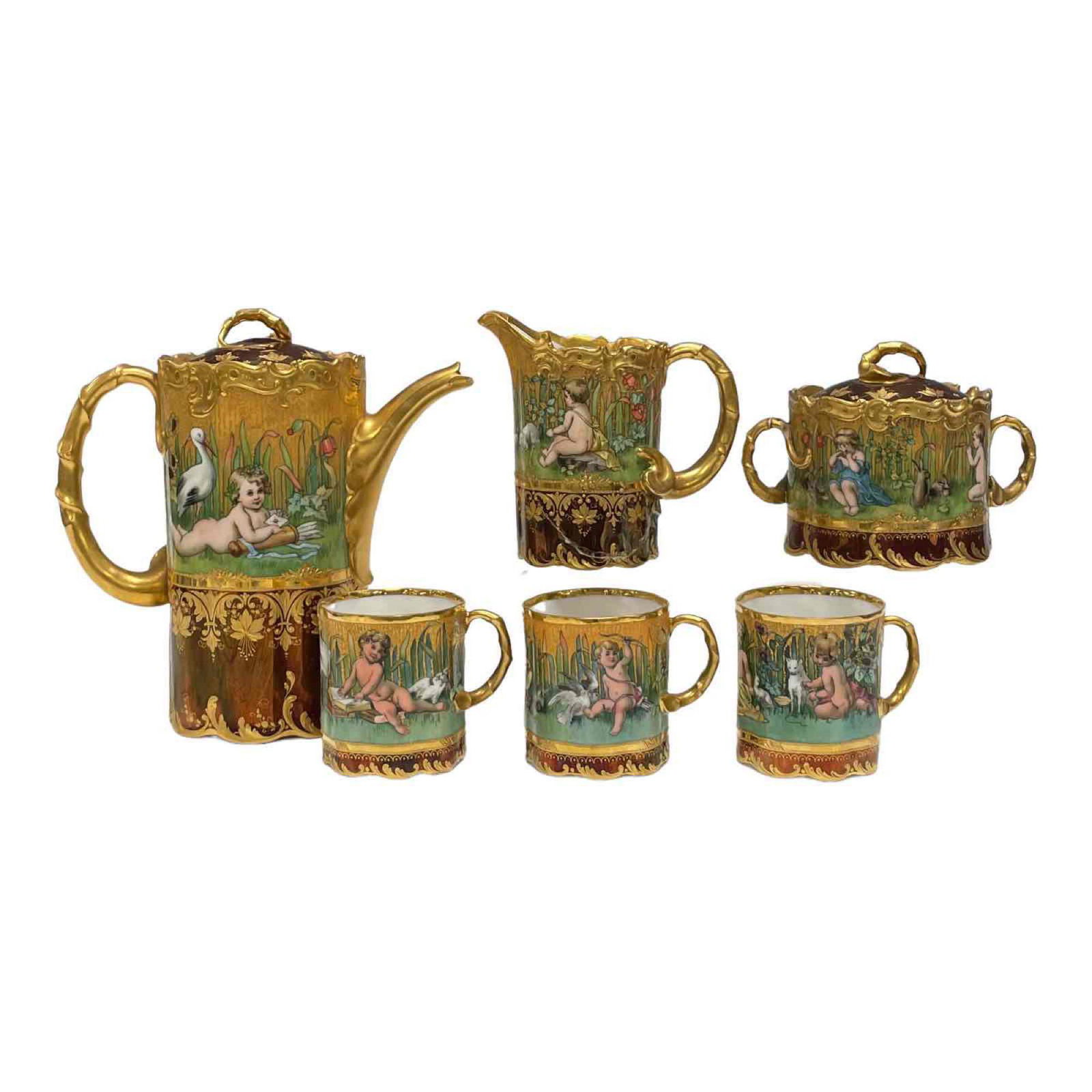 19th C. Austrian Royal Vienna Gold Gilt Porcelain Tea Set: A fine and highly decorated 19th century Austrian hand painted Royal Vienna porcelain tea service set. Fully decorated with cupids and young children, animals and more with a burgundy wine main color