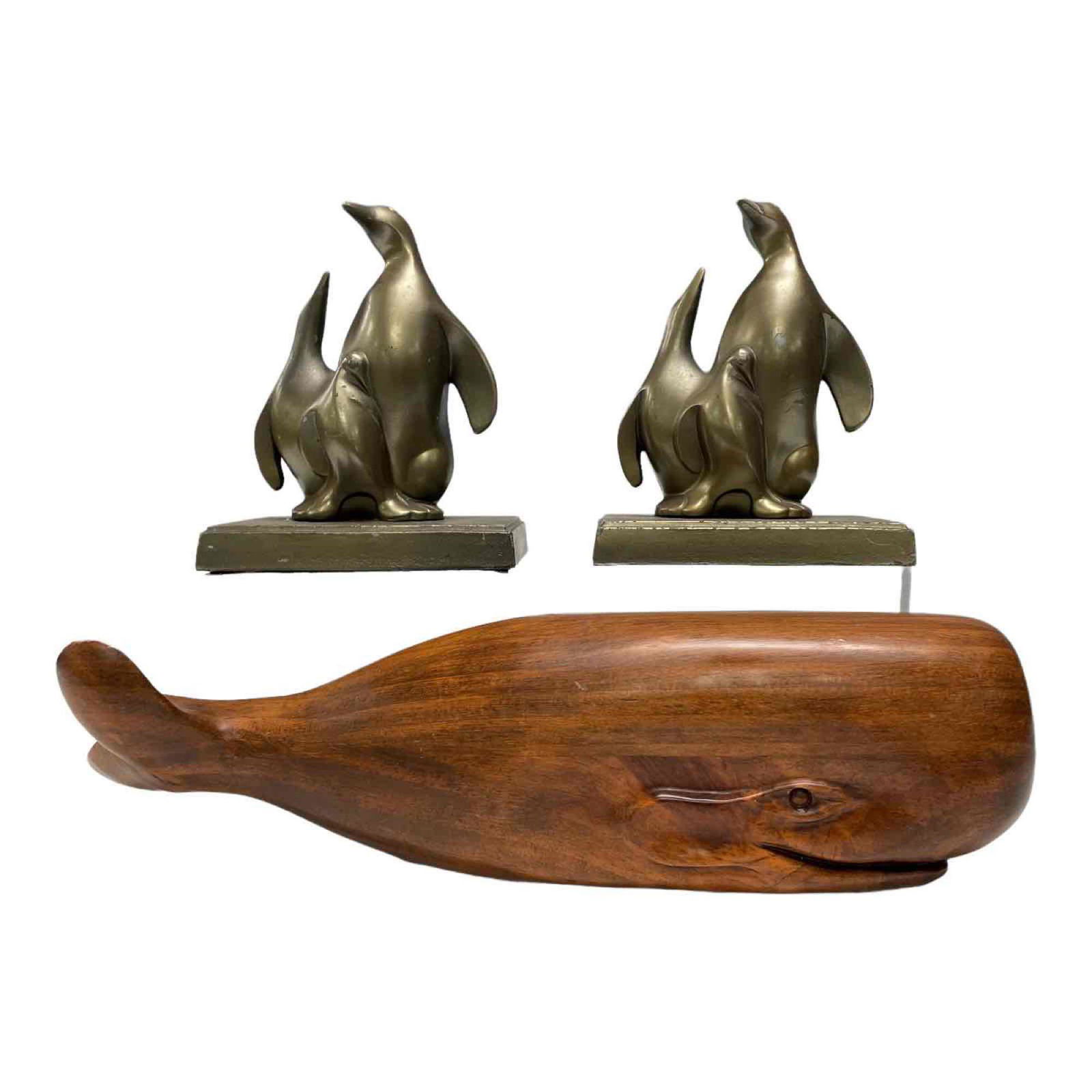 Carved Wood Whale and Penguin Bookends: Handcrafted wooden whale sculpture 13 1/2" long and pair of mother and baby penguins metal bookends 6" tall. Areas of finish losses to bookends, see photos.