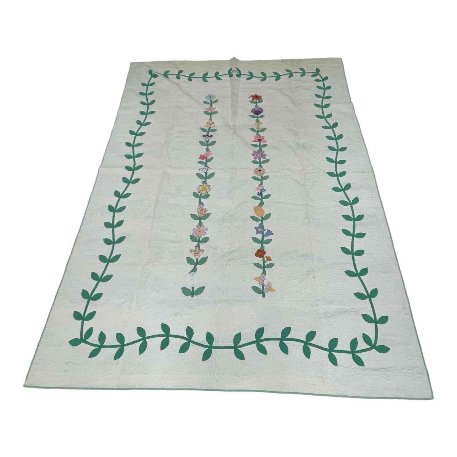 Hand Stitched Floral and Vine Quilt: Hand stitched vine and flower on white background quilt. Measuring approx. 93" x 67". In good age appropriate condition with some light stains, see photos.