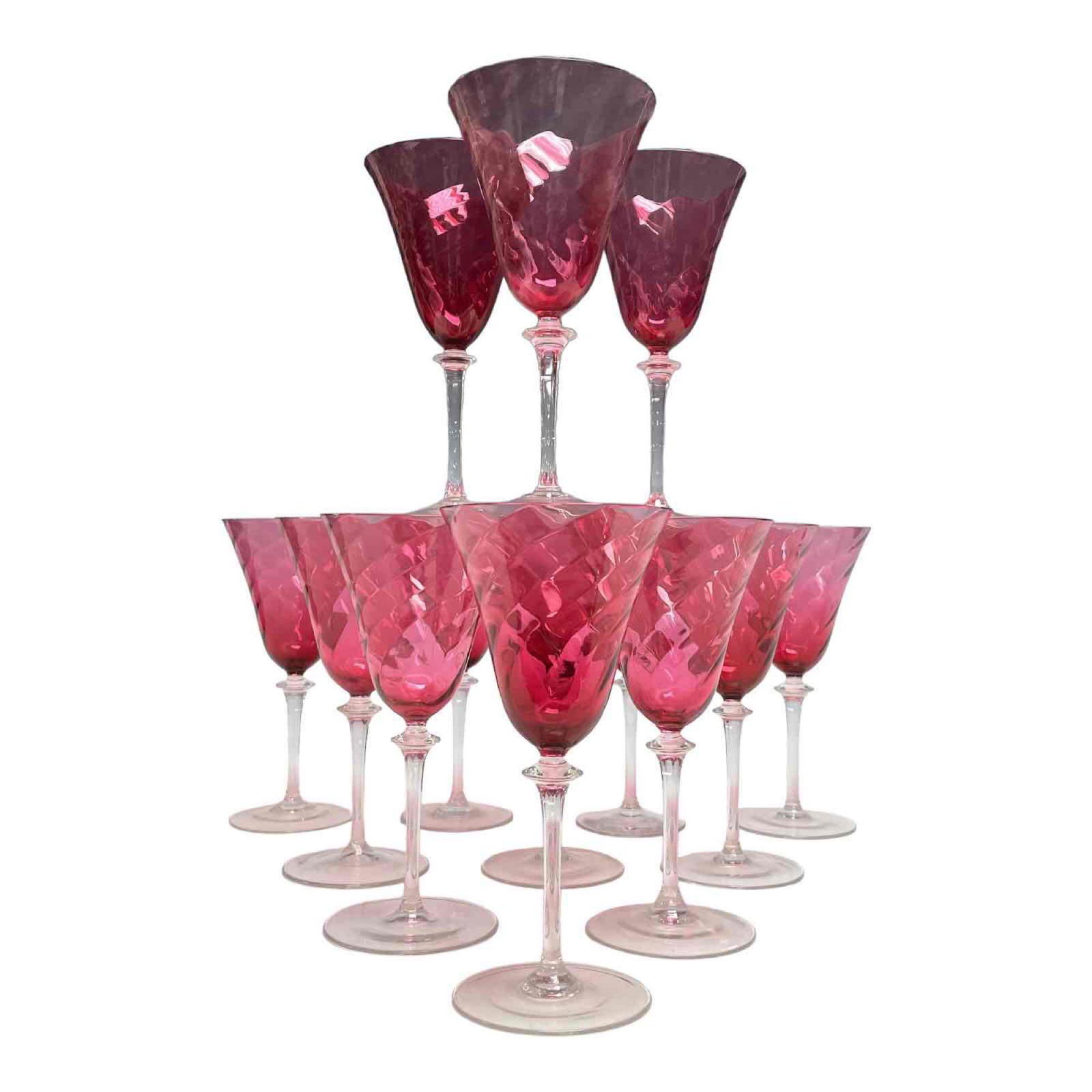 Twelve Steuben Cranberry Swirl Glasses on Colorless Stems: Large 8" tall wine stems having optic blown cranberry bowl seated on colourless stem and circular foot. Early 20th century, American. See photos. Some rim chips