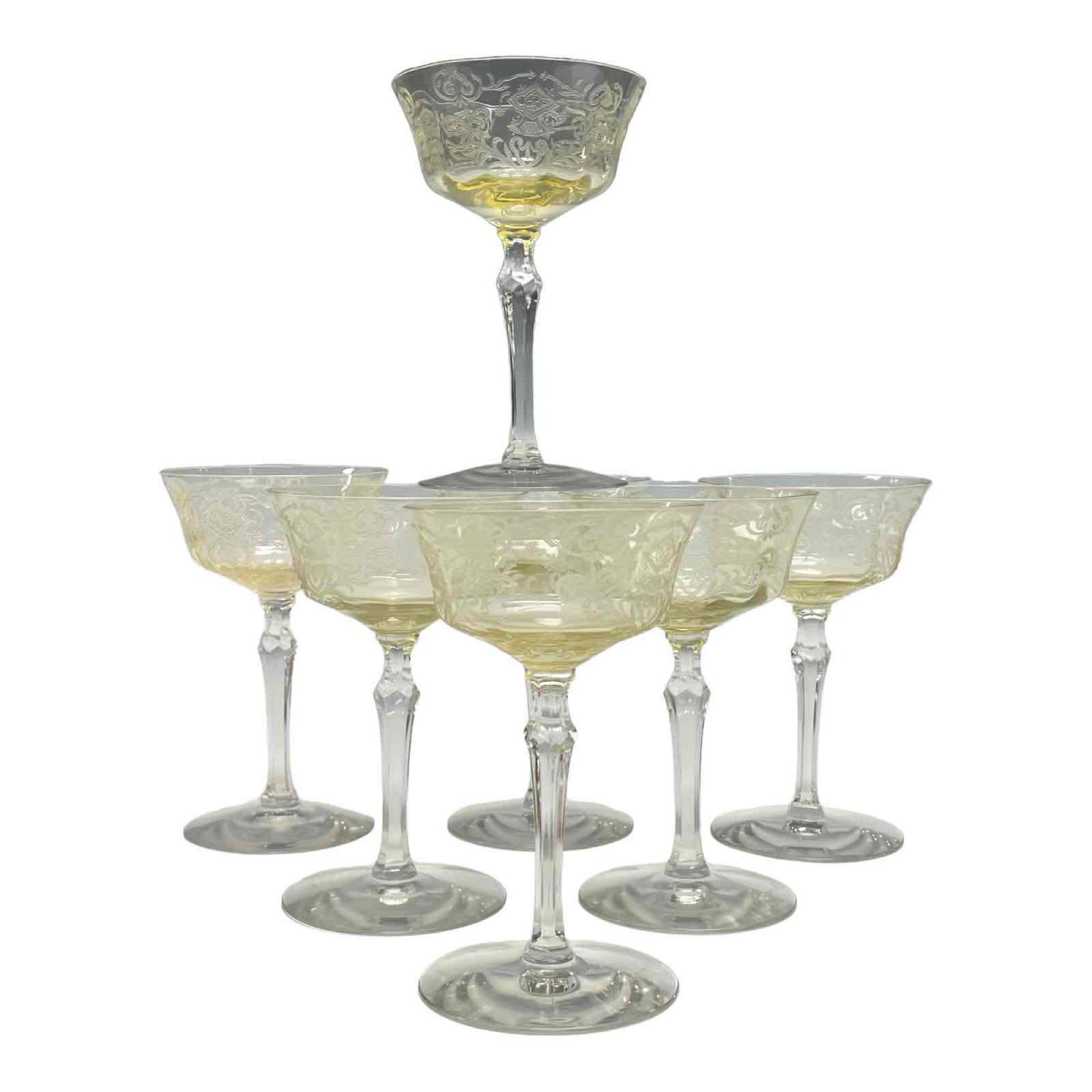 Seven Yellow Tinted Etched Wine Glass on Colourless Stems: Measuring approx 6.25" tall. Good condition as shown, see photos on has minor rim chip. Probably Tiffin or Cambridge glass