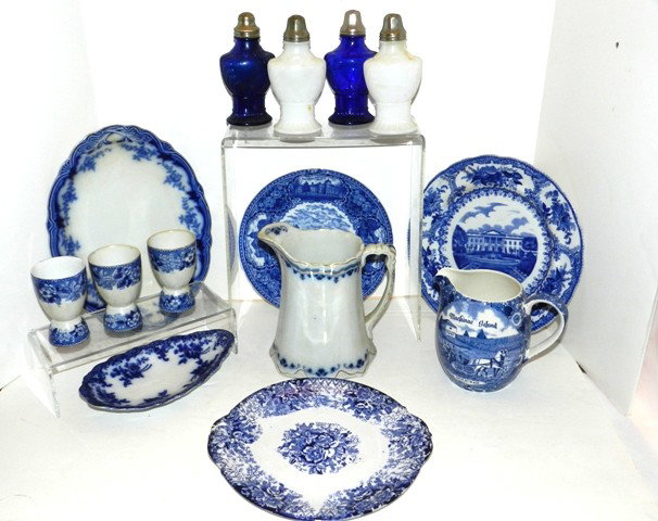 14 Piece Lot Of Flow Blue Collection Etc.: Royal Bonn, Staffordshire, Meakin and others. One collection with pitchers serving platter, cobalt shakers, white opaic shakers plates etc. All in fair to good condition. Minor chip on 2pcs