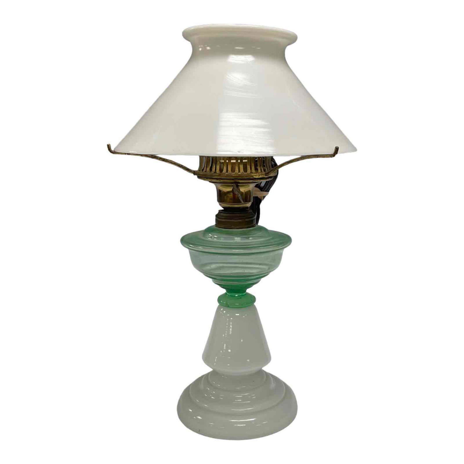 Early Converted Oil Lamp with Green Glass Font: Nice early American oil / kerosene lamp that has been electrified with white milk glass shade, opaline glass base and green font. Measuring approx 16" tall. Good working condition as shown, see photos