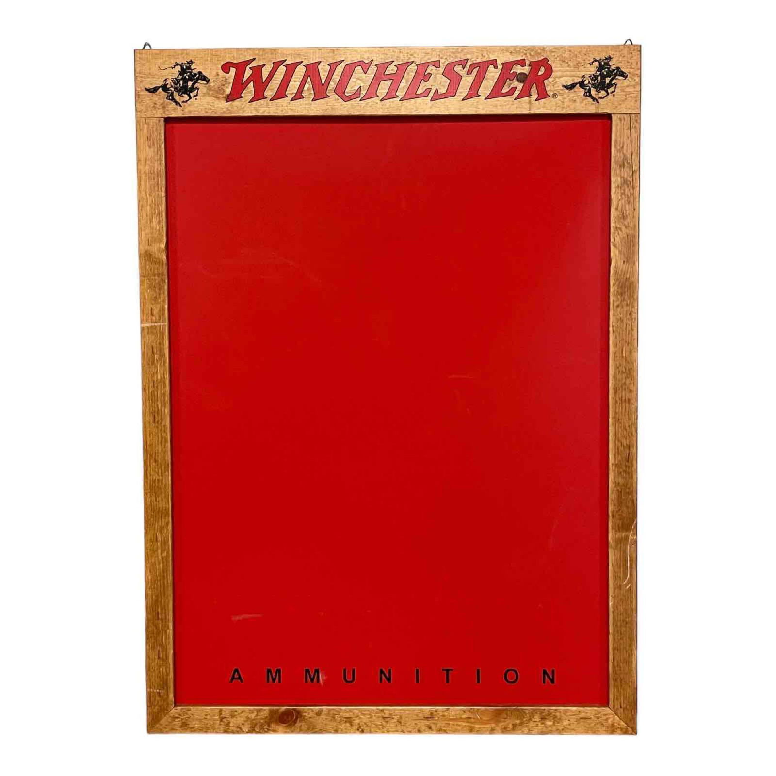 Winchester Riffle Advertising Bulletin Board: Nice addition to your gun room or cabin with this decorative wood framed with masonite center Winchester red with graphics on top as shown. 20th century measuring approx 26" x 36". Good condition as s