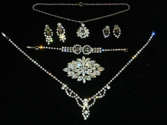 Trifari Rhinestone Jewelry Lot: Large clear stone brooch unmarked, several clip style earrings, necklaces. All in used, but good condition. All lots in this auction are consignments of the Well known Harding Estate of Olmsted Falls,