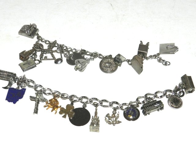 2 Sterling Silver Charm Bracelets: 2 Bracelets loaded with various collector sterling charms. Approx 3ozt All lots in this auction are consignments of the Well known Harding Estate of Olmsted Falls, OH.