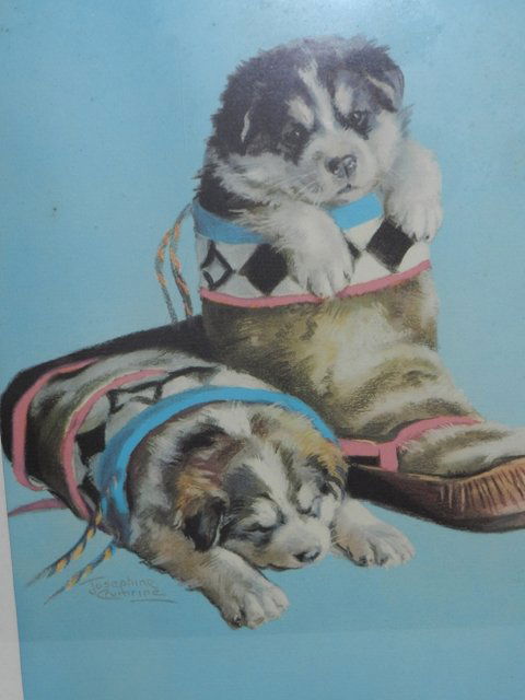 Josephine Crumrine Puppy Print: Framed Alaskan artist Josephine Crumrine print f 2 small pups in plying in Eskimo boots. Approx 18" x 22" with frame. Some dis coloring on matte area. All lots in this auction are consignments of the