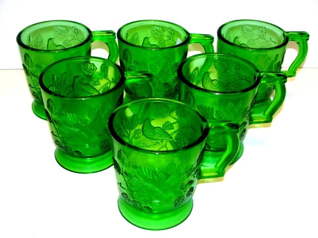 EAPG Emerald Green Mugs With Birds & Foliage: Total of 7 mugs, bird in motion one side either sitting amongst tree branches. Age or maker unknown. Condition very good no chips. 3 3/4'' H.
