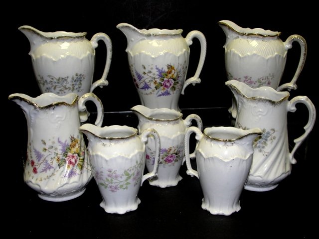 Group Of Seven Cream / Syrup Pitchers Jugs: Some in same patterns see photos closely. Condition all good no chips. Largest 6 1/4'' to spout, 3 smallest 4 3/4'' to spout. From Harding Estate