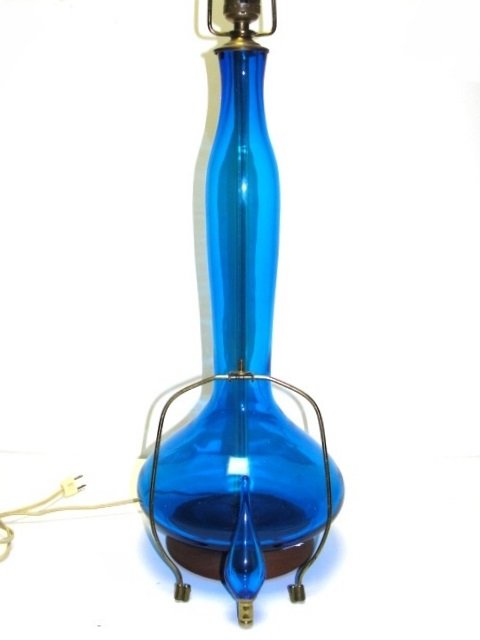 Blenko Mid Century Tall Blue Table Lamp: Appearing to be sapphire blue glass vases made by the Blenko Glassworks. Ca. 1975. Paper label gone. Wood base with original stopper and white pleated shade. From Harding Estate
