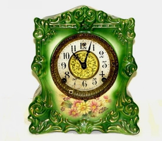 Porcelain Royal Bonn Style Green Cased Clock: Made by Gilbert Clock Co. Ca. 1900. Condition case very good no chips or cracks, no key, back cover plate or pendulum. Not tested appears to click but maybe wound tight. H. 10'' W. 9'' D. 5''.